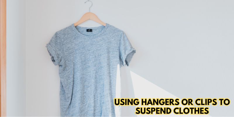 Using hangers or clips to suspend clothes